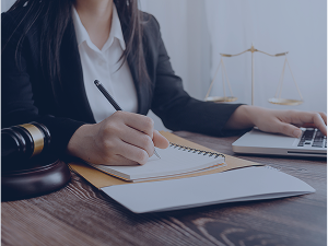 Business lawyers discussing contract papers with brass scale office desk
