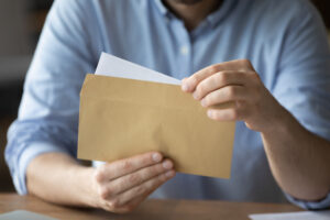 Businessman takes out letter from envelope with business news