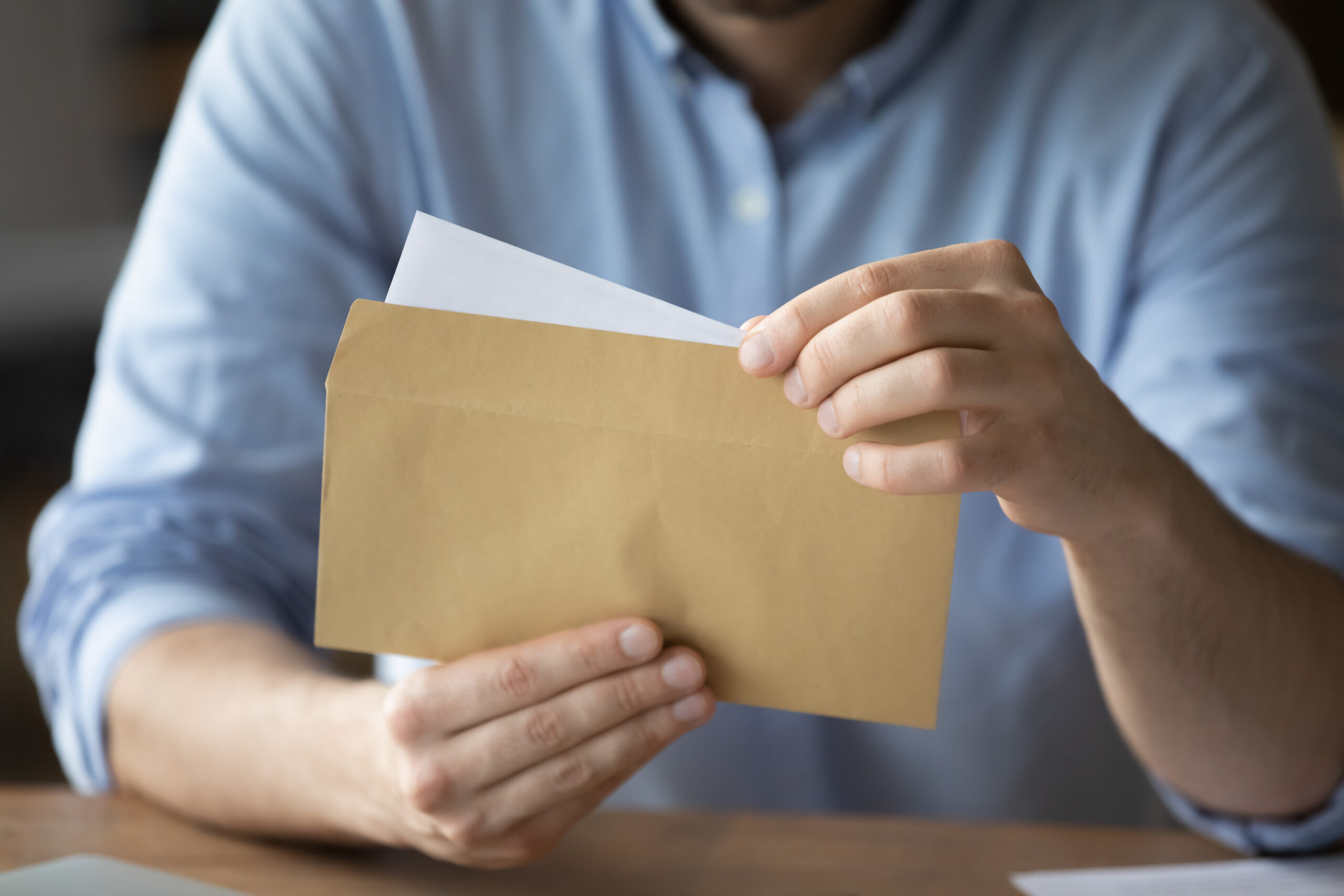 Businessman takes out letter from envelope with business news