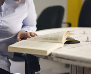 Woman reading book at table