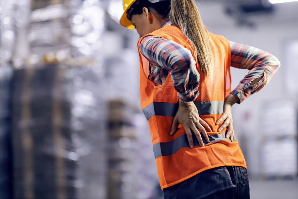Female warehouse worker having back pain