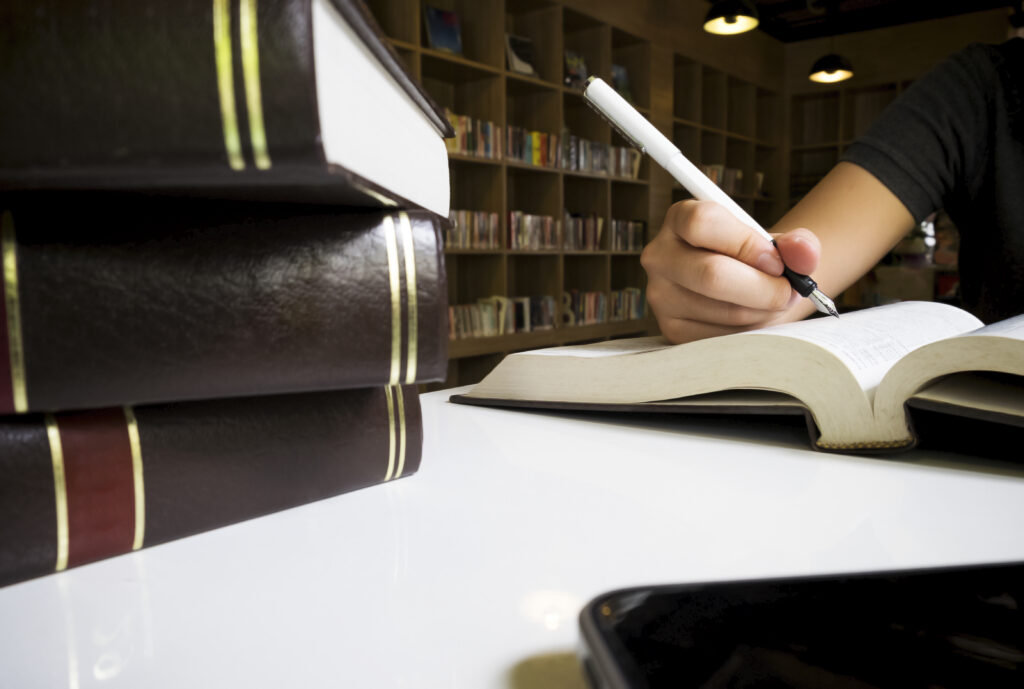 Woman reading book in library