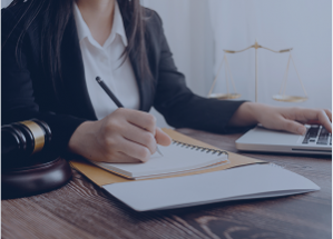 Business lawyers discussing contract papers with brass scale office desk